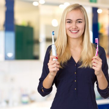 Electric toothbrushes in womans hands
